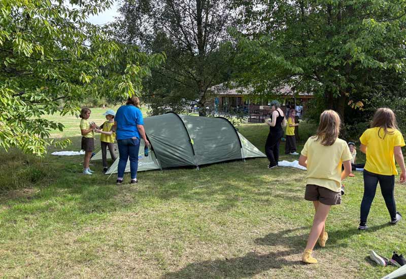 Young people enjoying outdoor activities at Sandy Acres Campsite